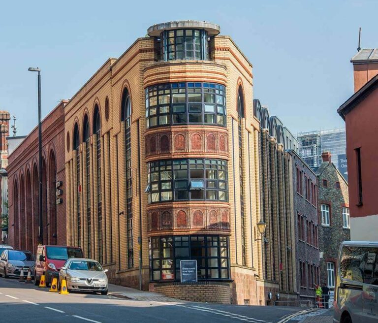 Historic curved brick building with large arched windows
